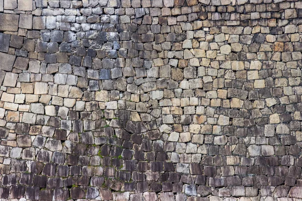 Texture of old stacked stone wall have grass along the rock. — Stock Photo, Image