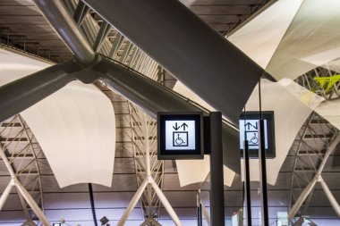 Tekerlekli sandalye Kansai Uluslararası Havaalanı asansörde işaret etiketleri.