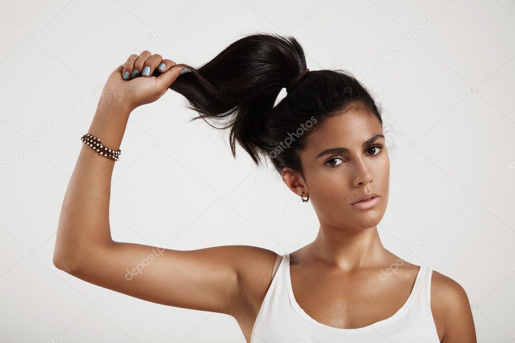 spanish woman hold her hair in hand
