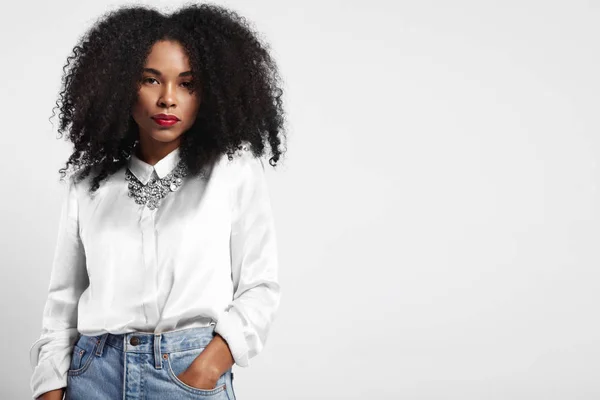 Black woman wears jeans and white silk shirt. — Stock Photo, Image