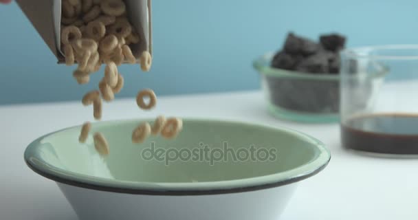 Corn flakes rings falling on a bowl slow motion. Breakfast theme footage — Stock Video