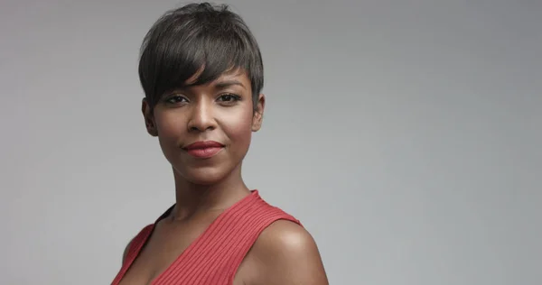 Mixed race black woman in red dress dancing and posing to camera — Stock Photo, Image