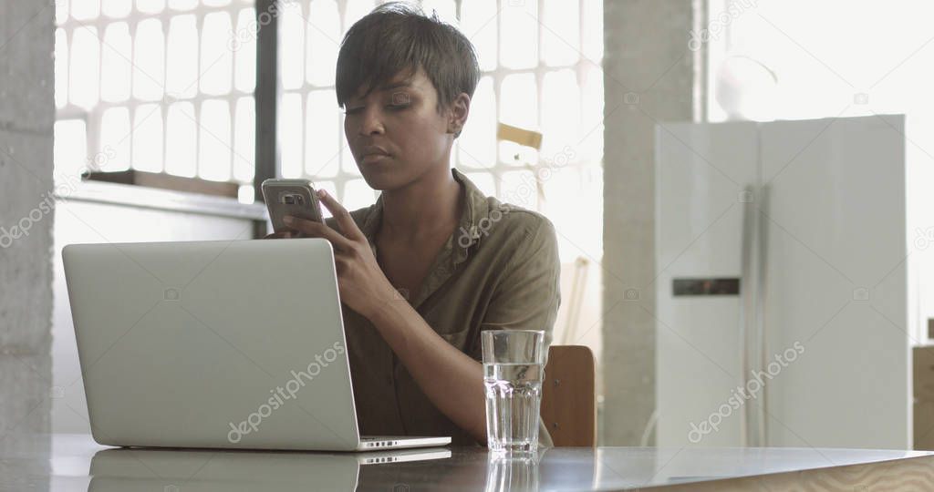 Cute young black woman in loft style office