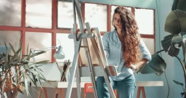 Sevimli kırmızı saçlı kız boyalar onun Studio