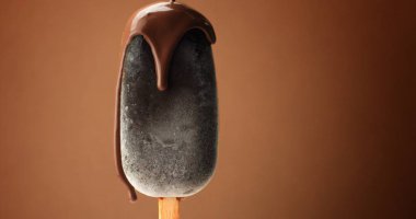 chocolate ice cream on a stick and liquid chocolate covered it. Different chocolate textures clipart