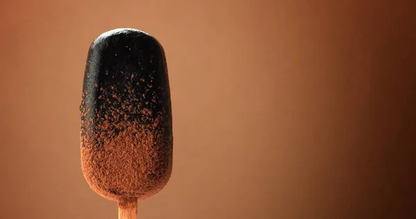 Chocolate ice cream on a stick and liquid chocolate covered it. Different chocolate textures — Stock Photo, Image