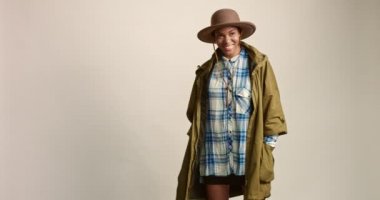Happy black female model dressed to explore the outdoors