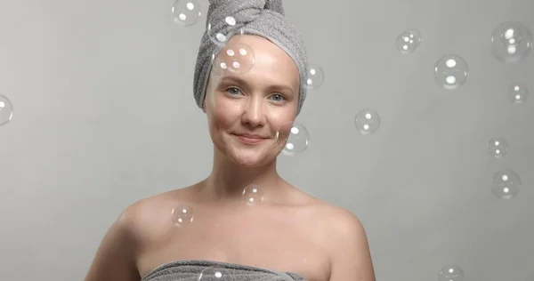 30s vrouw draagt een handdoek na bad omgeven door zeepbellen — Stockfoto