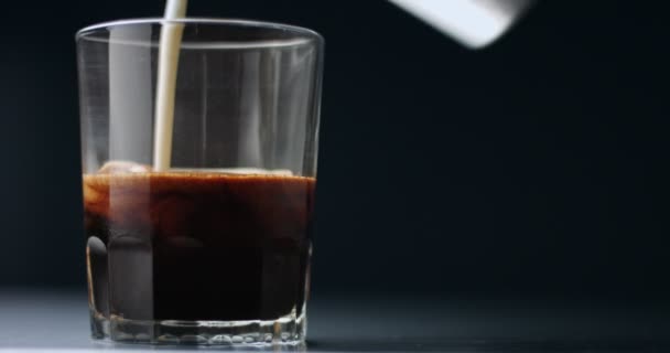 Pouring milk into espresso 