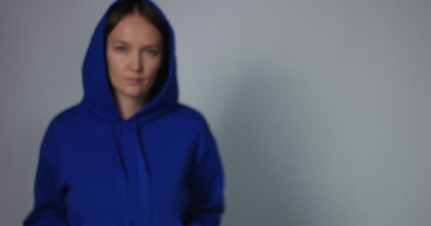 Frau in leuchtend blauem Pullover tritt in den Fokus — Stockvideo