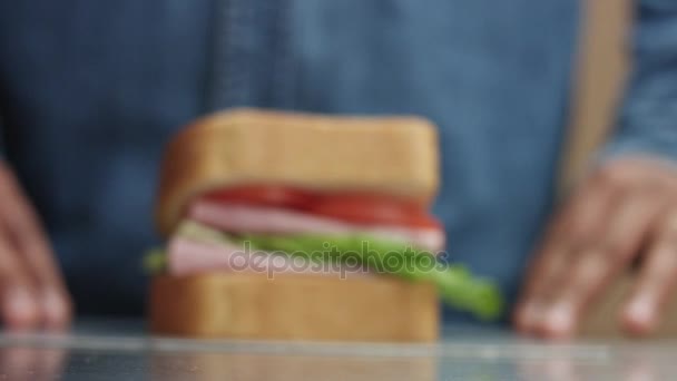 Mans hand moving the sandwich to focus zone to camera — Stock Video