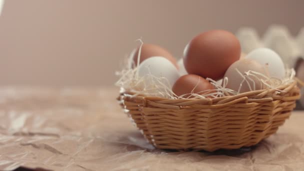 Womans hant put an egg to basket to another ones — Stock Video