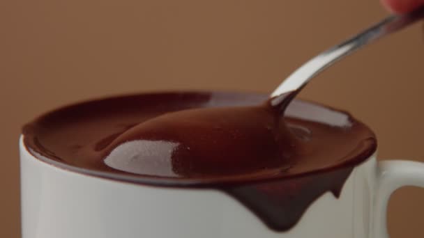 Spoon in cup of hot chocolate — Stock Video