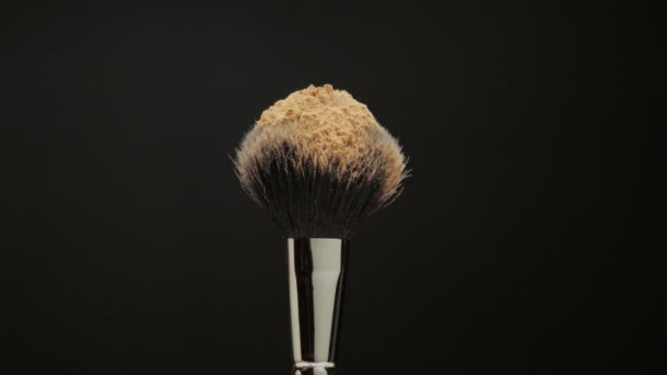 Closeup of black brush with a facial powder on it — Stock Video