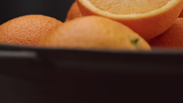 Nahaufnahme von Orangen auf schwarzem Hintergrund — Stockvideo