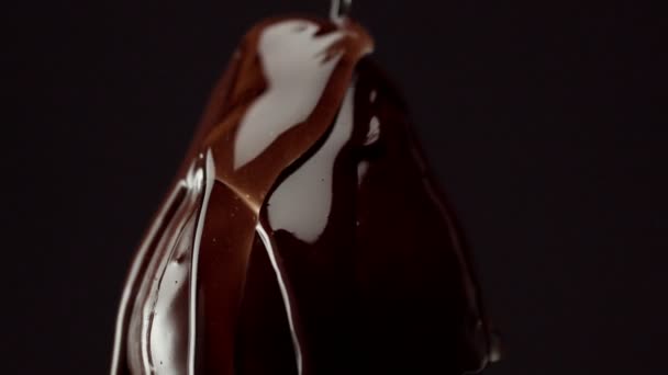 Strawbery on black, covered by chocolate — Stock Video