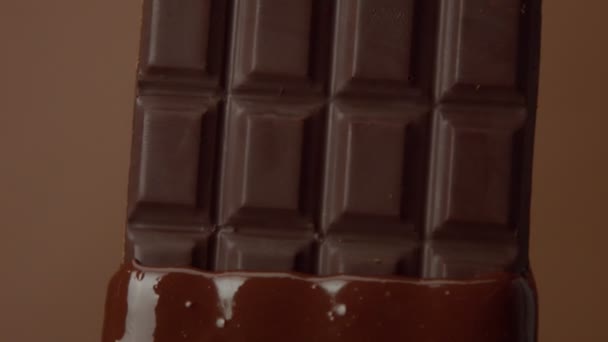 Barra de chocolate negro primer plano empapado en chocolate líquido — Vídeo de stock