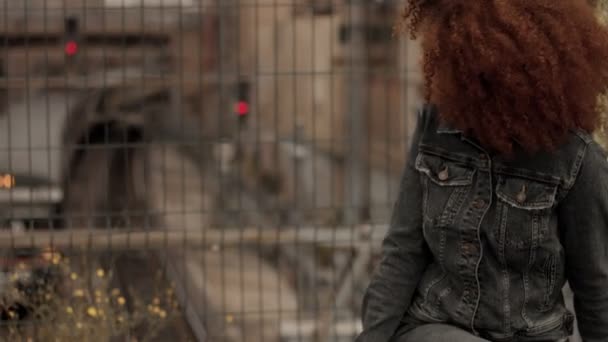 Mujer de raza mixta negra con gran pelo afro rizado en la ciudad al aire libre — Vídeos de Stock