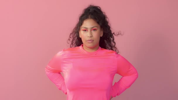Νεαρή γυναίκα στο στούντιο με ροζ χρώμα φοράει ζιβάγκο νέον και νέον μέικ απ — Αρχείο Βίντεο
