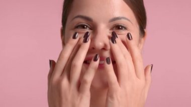 30 'lu yaşlardaki esmer kadın göz masajı yaptırıyor.