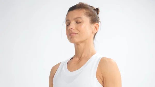 Senior woman in white space practice yoga Closeup portrait with eyes closed — Stok fotoğraf