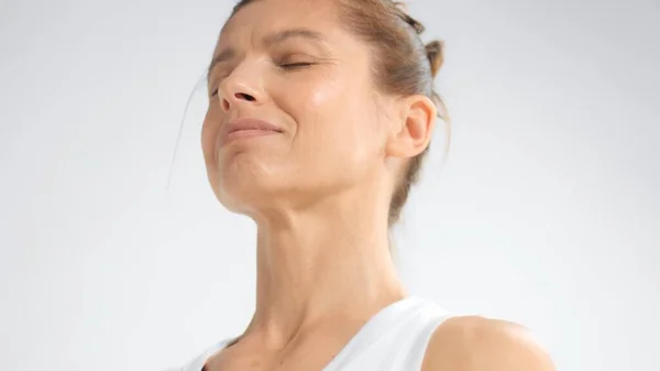 Senior woman in white space practice yoga Closeup portrait with eyes closed — Stok fotoğraf