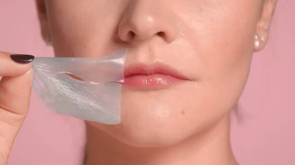 Unrecognizable womans lips closeup takes off her lips patch — Stock Photo, Image