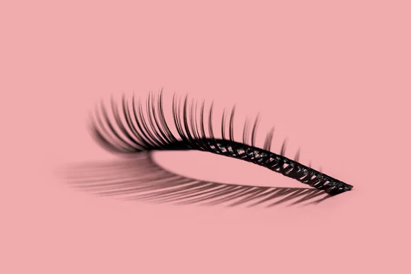 A pattern of false lashes on pink — Stock Photo, Image