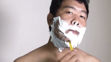 Adam banyoda tıraş gösterilen.