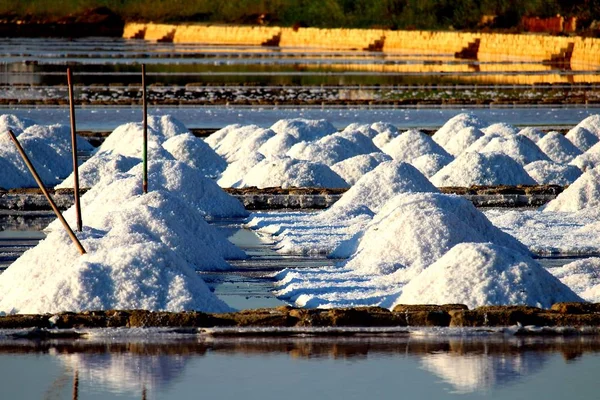 Stagnone Nature Reserve or natural reserve of the \'Saline dello Stagnone\' near Marsala and Trapani, Sicily, Italy, heaps of salt near the salt flats at sunset