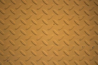 Soyut kabartma desenli sarı metal plaka dokusunun anımsatıcı görüntüsü