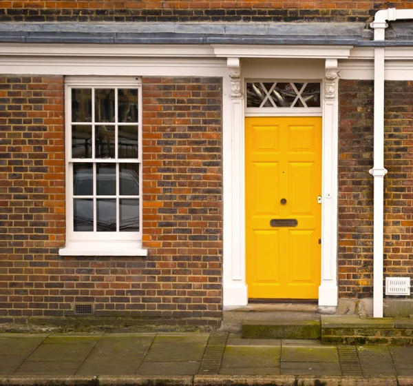Traditional entrance door of yellow colour in london Stock Image