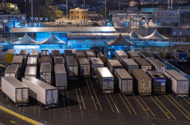 Civitavecchia, Rome, Italy - Night photo - transportation trucks shipping goods are waiting to be loaded on the ferry at the terminal. clipart