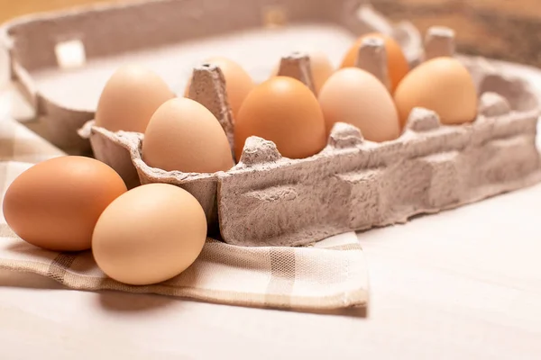 Egg tray on white table, eggs with selective focus, close up