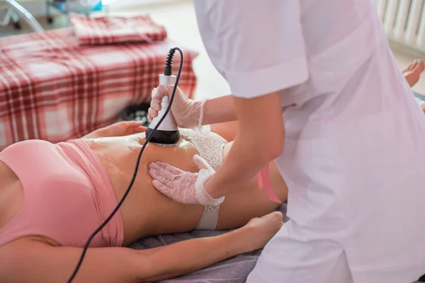 Procedur ta bort celluliter på kvinnlig buk, kavitation mage massage. Ultraljudsmassage för viktminskning. Korrigering av en kvinnlig figur utan kirurgiskt ingrepp. Närbild av magen. — Stockfoto