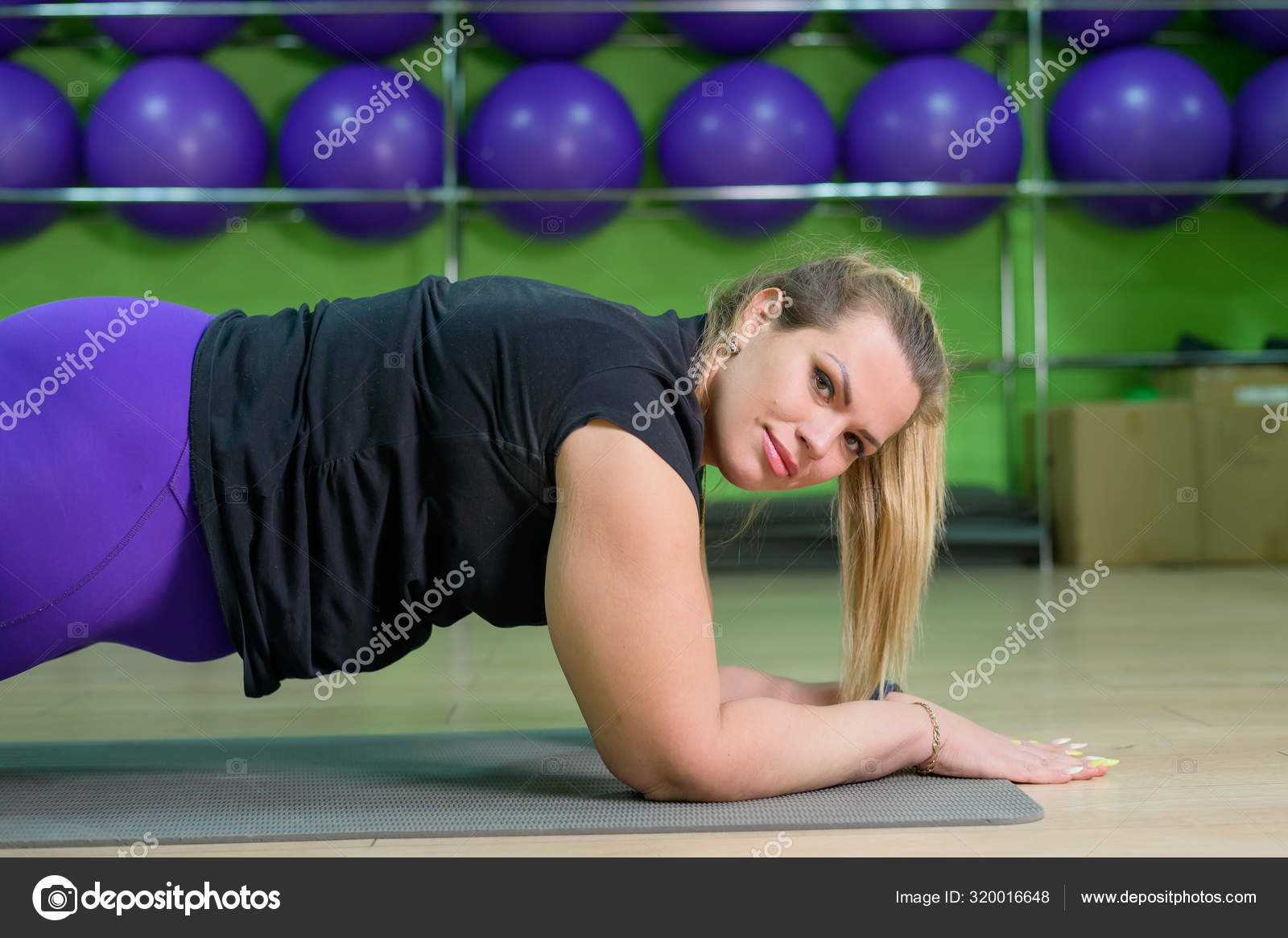 A fat woman is engaged in aerobics and trying to lose weight. An