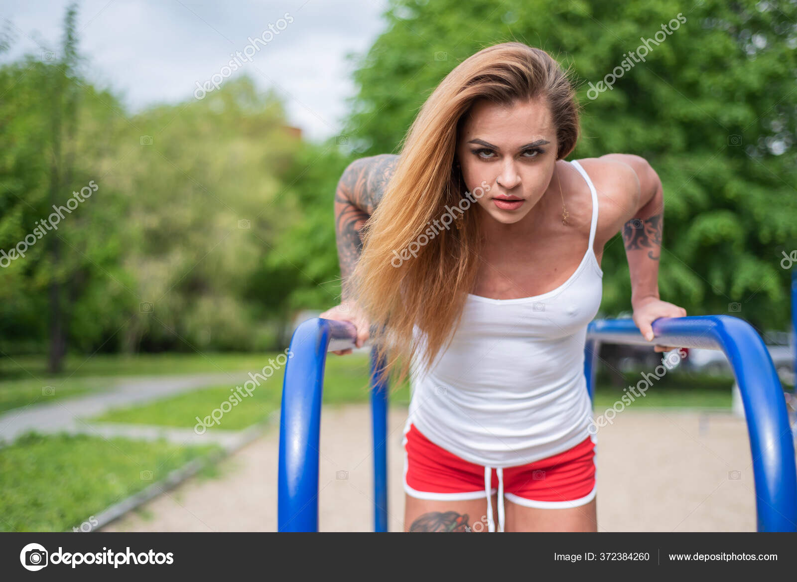 Short Muscular Girl Athletic Woman Doing Triceps Exercises On The