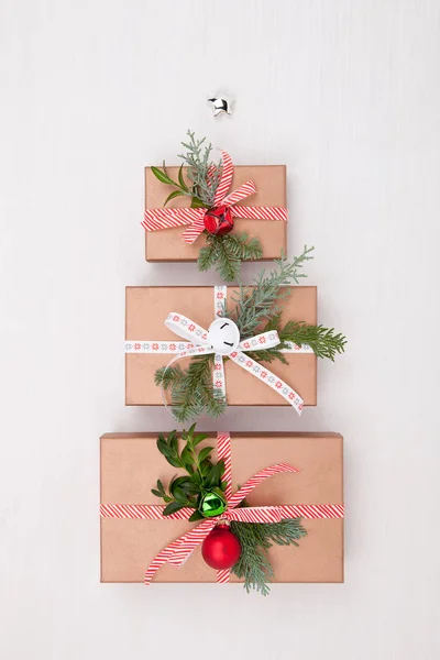 Christmas composition. Gifts, fir tree branches, jingle bells on — Stock Photo, Image