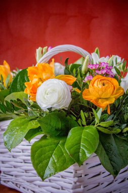 Çiçekler beyaz el yapımı sepet içinde