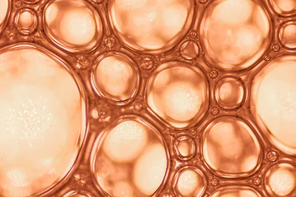 Chemical macro view white soapy bubbles foam. suds and shower texture. Blue background. soft focus