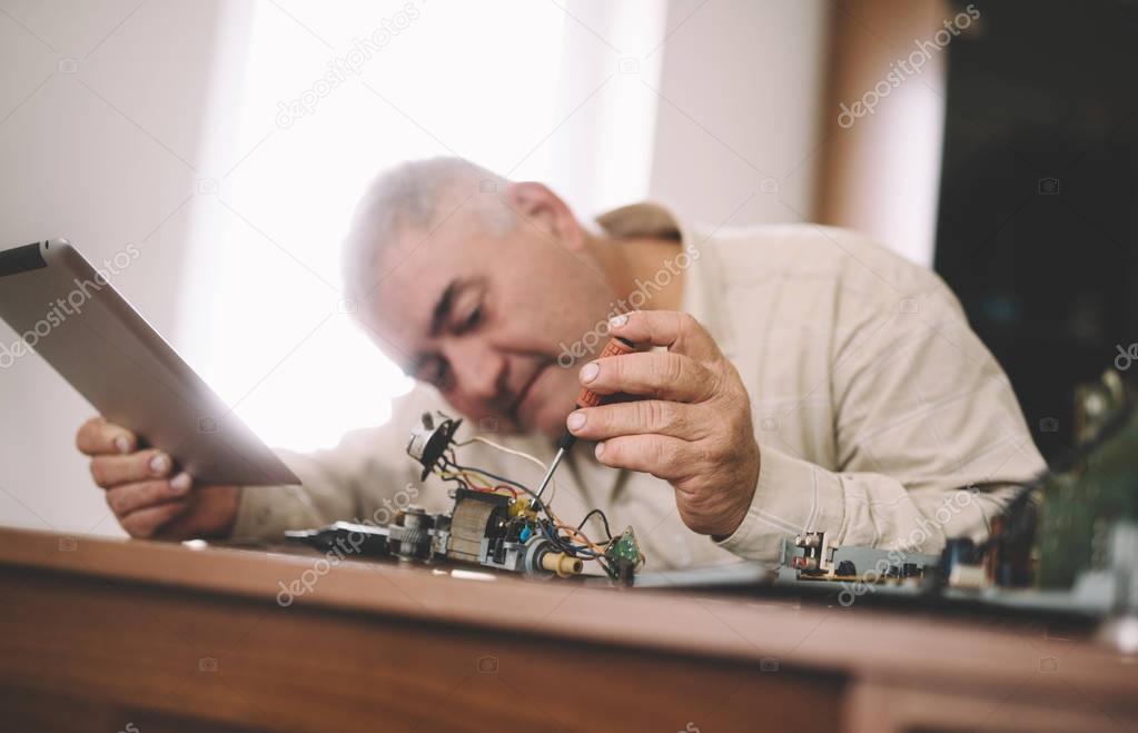 Man fixes electronics