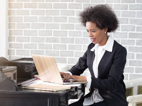 African American woman in business suits using wireless internet on laptop. Business woman working at home, online business. Business,Technology or Women\'s day concept.