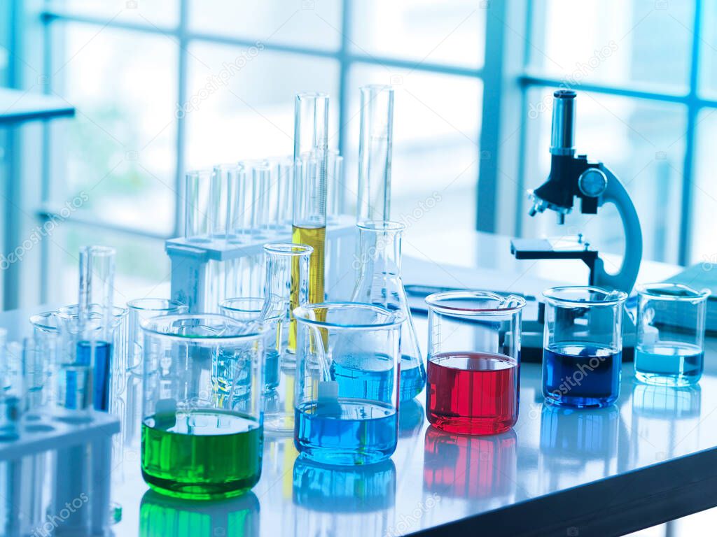 green, blue, red , and dark blue color liquid in glass beaker and yellow one in tube at the laboratory for researchers to do their work.