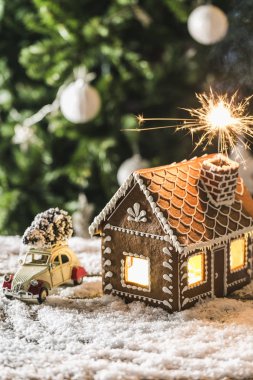 Gingerbread house with a Sparkler on the background of a Christm clipart
