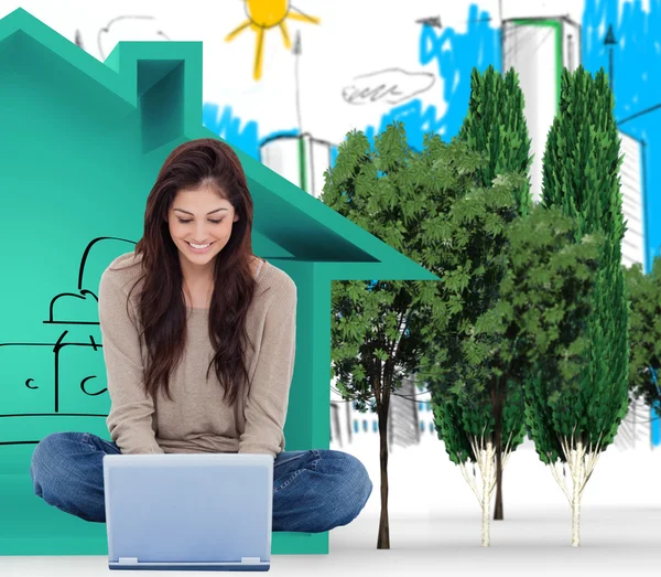 Brunette on floor using laptop — Stock Photo, Image