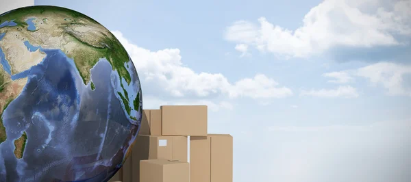 Earth surrounded by cardboard boxes — Stock Photo, Image