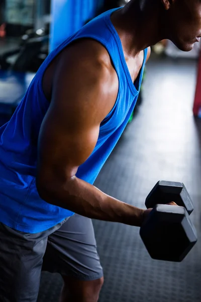 Male athlete exercising with dumbbell — Stock Photo, Image