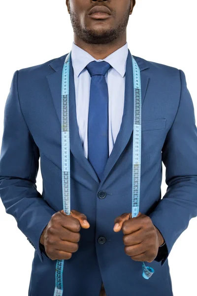 Businessman holding measuring tape around is neck — Stock Photo, Image