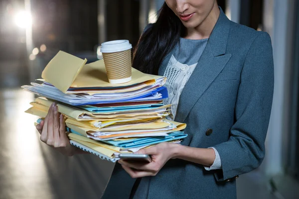 Geschäftsfrau trägt Stapel von Aktenordnern bei sich — Stockfoto