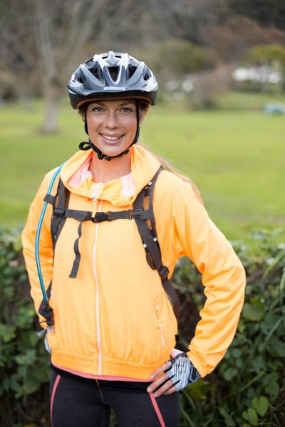 Female biker smiling in countryside — Stock Photo, Image